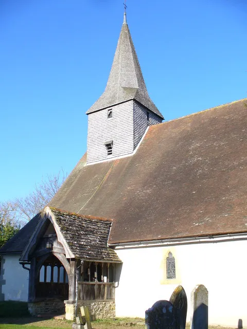 South Porch, Alfold Church Village church with a small shingled tower. The church has Norman roots.