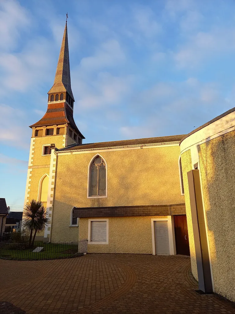 Southern elevation of St. Brigit's church, Blanchardstown. Picture taken in the car park a few minutes before sunset, 6 January 2021. Features the Flemish spire.