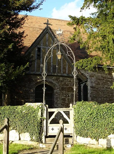 Lantern gate at Boughton Malherbe church. This wrought iron lantern gate bears the date 1897 topped with a crown - possibly because Queen Elizabeth I once stayed at nearby Boughton Place.