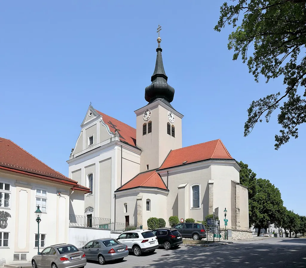 Südostansicht der röm.-kath. Pfarrkirche hl. Martin in der niederösterreichischen Marktgemeinde Ernstbrunn. Die hochbarocke Saalkirche wurde um die 17./18. Jahrhundertwende errichtet, wobei der im rechten Winkel herausragende gotische Chor, der Turm und die Seitenkapelle der geosteten Vorgängerkirche miteinbezogen wurde.