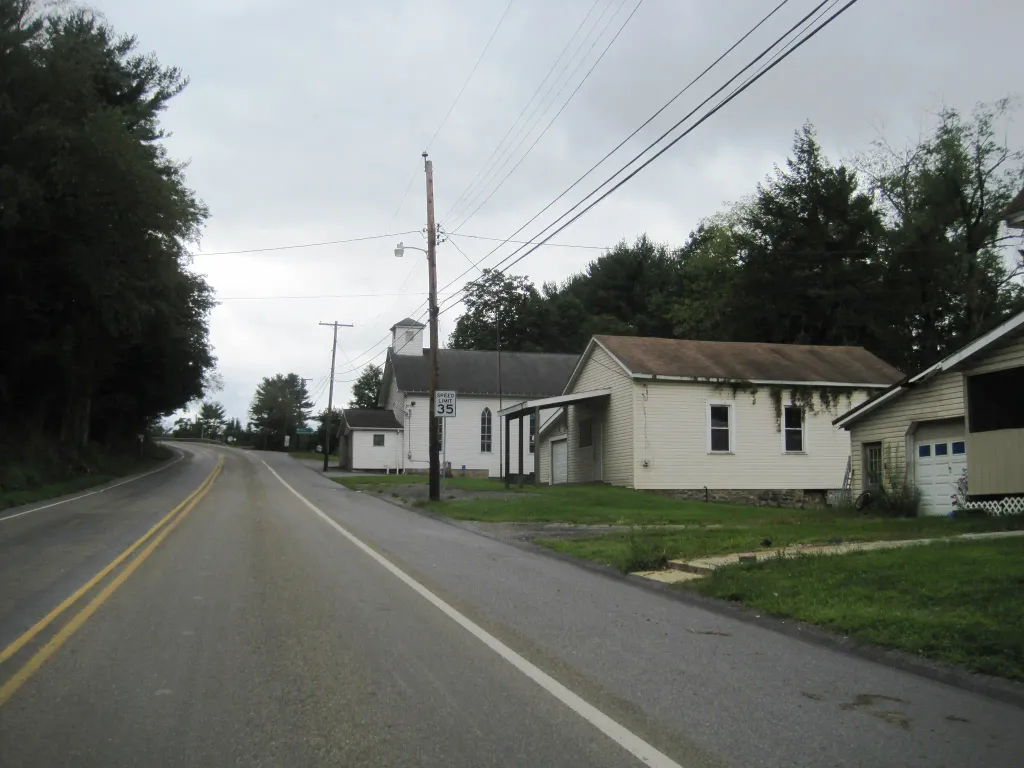 Photo of southbound Pennsylvania Route 36 (westbound Main Street) in Newburg, Clearfield County, Pennsylvania showing the borough hall (middle building). Photo taken looking west-southwest between La Jose Road and Town Road.