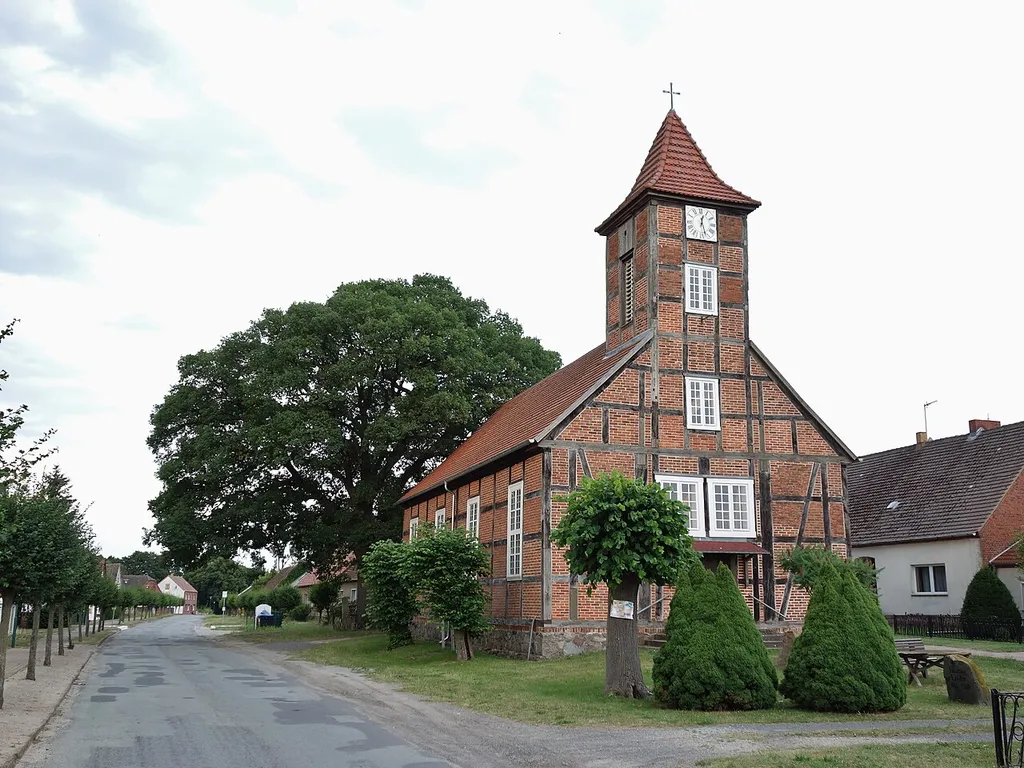 North-western view of church in Vettin, Groß Pankow municipality, Prignitz district, Brandenburg state, Germany. Behind the church the oak-tree commemorating the 1870 Prussian victory against France is seen.