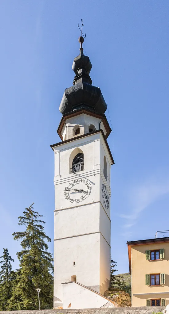 Mountain tour from Prümaran Prui via Alp Laret to Ftan. Reformierte Kirche Ftan. Tower of the church in Ftan.