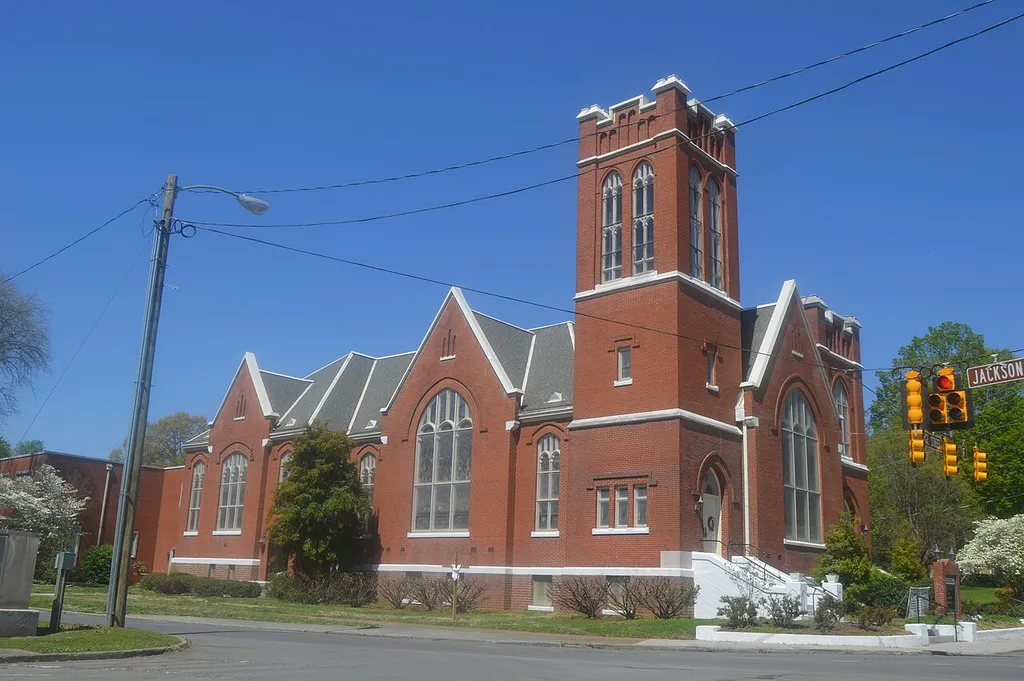 Front and western side of Trinity United Methodist Church, located at 100 E. College Street in Athens, Tennessee, United States. Built in 1910, it is listed on the National Register of Historic Places.