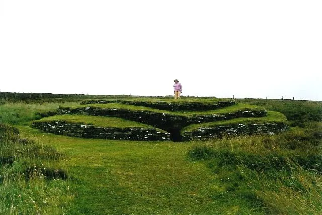 Wideford Hill cairn. Interesting layered appearance from the outside, the inside is reached through the top rather than the original passage at the front; inside there are a number of small chambers around the central one. Looking east.