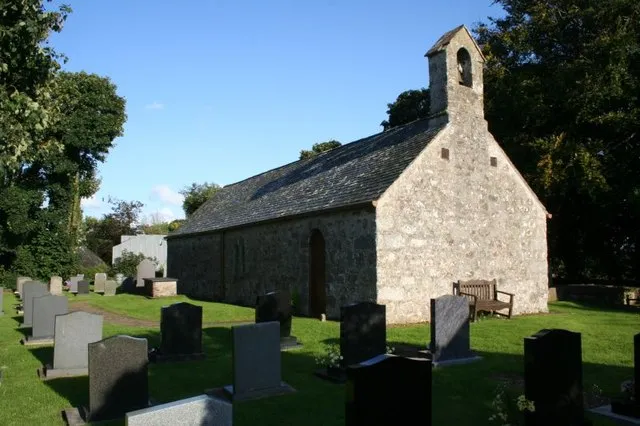 View across the graveyard at the west end of the St Mary at Llanfair yn y Cwmwd. The entrance is through the door you see on the left. I did try and have a look inside but the door was locked. If you look through the windows at first you think the church is lit by oil lamps but on closer inspection you can see light bulbs.