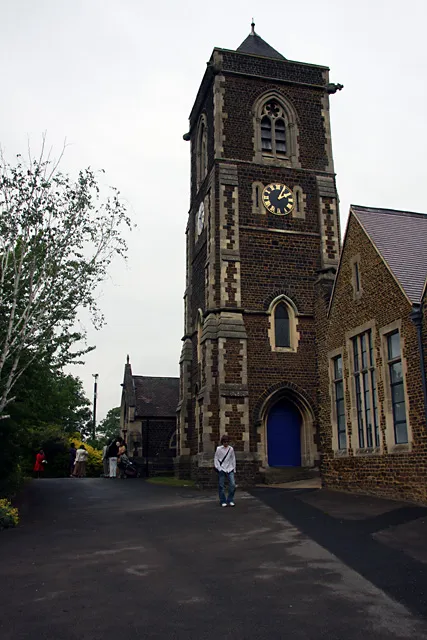 St. Barnabas Church Located on the edge of Linslade Recreation Ground. A wedding party mills around outside the door while one of the locals walks through. The church was built in 1849 to meet the needs of the fast growing town, the nearby St. Mary's being considered too small. The tower was added in 1869.
