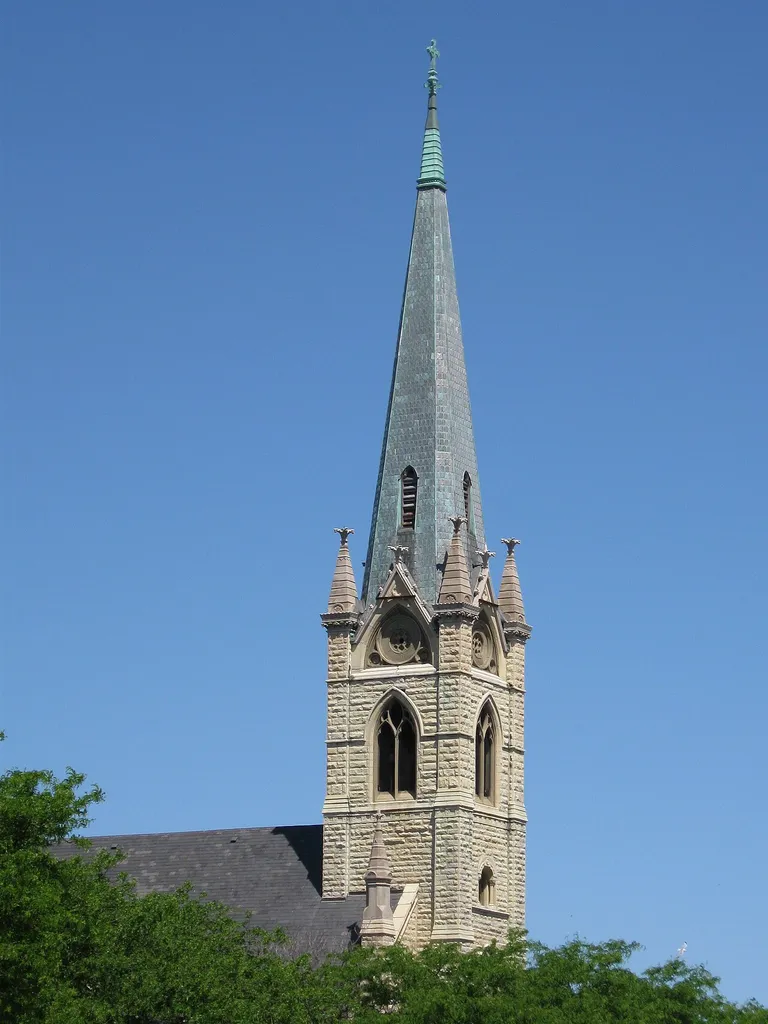 Steeple of Roman Catholic St. James Church at 2940 S. Wabash Street in Bronzeville, Chicago, USA. The St. James Church, built by the Patrick C. Keely, from 1875 to 1880 suffered from a fire on 22 December 1972. The church was restored by Paul Straka between 1974 and 1975. The St. James parish dates back to 1855, then an Irish immigrant congregation. St. James became the “Mother Church” of many Southside parishes. The building was demolished in June 2013.