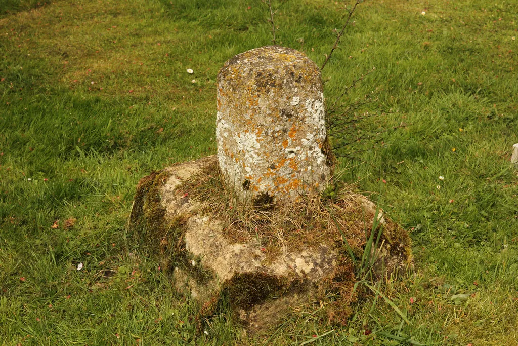 Base and truncated shaft of former stone cross in St Margaret's parish churchyard, Roughton, Lincolnshire