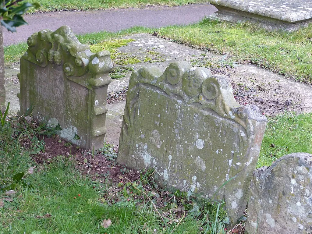 Two of a group of three listed headstones in the churchyard at Goodrich, Herefordshire. Listed as "Group of three headstones approximately 3 metres south-west of south porch of Church of St Giles". .mw-parser-output .messagebox{margin:4px 0;width:auto;border-collapse:collapse;border:2px solid var(--border-color-progressive,#6485d1);background-color:var(--background-color-neutral-subtle,#fbfcff);color:var(--color-base,#202122);box-sizing:border-box;border-inline-start-width:8px}.mw-parser-output .messagebox.mbox-small{font-size:88%;line-height:1.25em}.mw-parser-output .mbox-warning,.mw-parser-output .mbox-speedy{border:2px solid var(--border-color-error,#b22222);background:var(--background-color-error-subtle,#ffdbdb);border-inline-start-width:8px}.mw-parser-output .mbox-serious,.mw-parser-output .mbox-delete,.mw-parser-output .mbox-stop{border:2px solid var(--border-color-error,#b22222);border-inline-start-width:8px}.mw-parser-output .mbox-issue,.mw-parser-output .mbox-content{border:2px solid #f28500;background:var(--background-color-warning-subtle,#ffe);border-inline-start-width:8px}.mw-parser-output .mbox-query,.mw-parser-output .mbox-style{border:2px solid #f4c430;background:var(--background-color-warning-subtle,#ffe);border-inline-start-width:8px}.mw-parser-output .mbox-shit{border:2px solid #960;border-inline-start-width:8px}.mw-parser-output .mbox-license{border:2px solid #88a;border-inline-start-width:initial}.mw-parser-output .mbox-legal{border:2px solid var(--border-color-notice,#666);background:var(--background-color-base,#fff);border-inline-start-width:8px}.mw-parser-output .mbox-honor{border:2px solid #ca3;background:var(--background-color-warning-subtle,#fcf4db);border-inline-start-width:8px}.mw-parser-output .mbox-growth{border:2px solid #8d4;background:var(--background-color-success-subtle,#d5fdf4);border-inline-start-width:8px}.mw-parser-output .mbox-move{border:2px solid #93c;border-inline-start-width:8px}.mw-parser-output .mbox-protection,.mw-parse