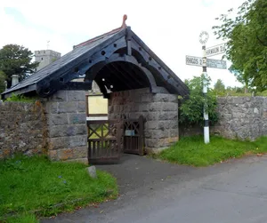 Churchyard wall, including pound & lych gate, at St Cynog's church