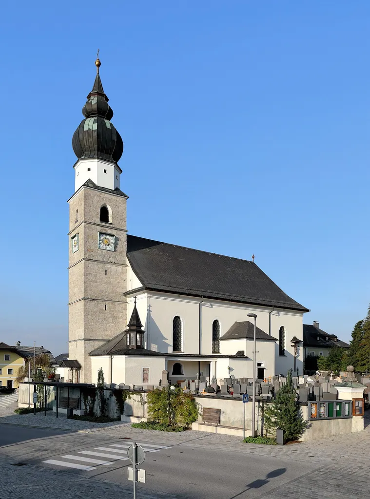 Südwestansicht der röm.-kath. Pfarrkirche hl. Martin in der Salzburger Gemeinde Eugendorf. Die Kirche wurde 1736/1737 nach den Plänen des Hofmaurermeisters Tobias Kendler anstelle einer Vorgängerkirche gebaut, 1763 geweiht und 1857 zur Pfarrkirche erhoben.