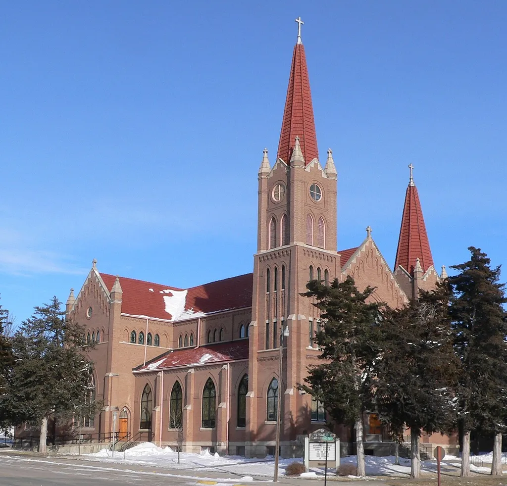 St. Michael's Church in Spalding, Nebraska; seen from the southwest. The church was designed in Gothic Revival style by architects J. H. Craddock and Jacob M. Nachtigall; its cornerstone was laid in 1908. The church is part of the St. Michael's Catholic Church Complex, which is listed in the National Register of Historic Places.