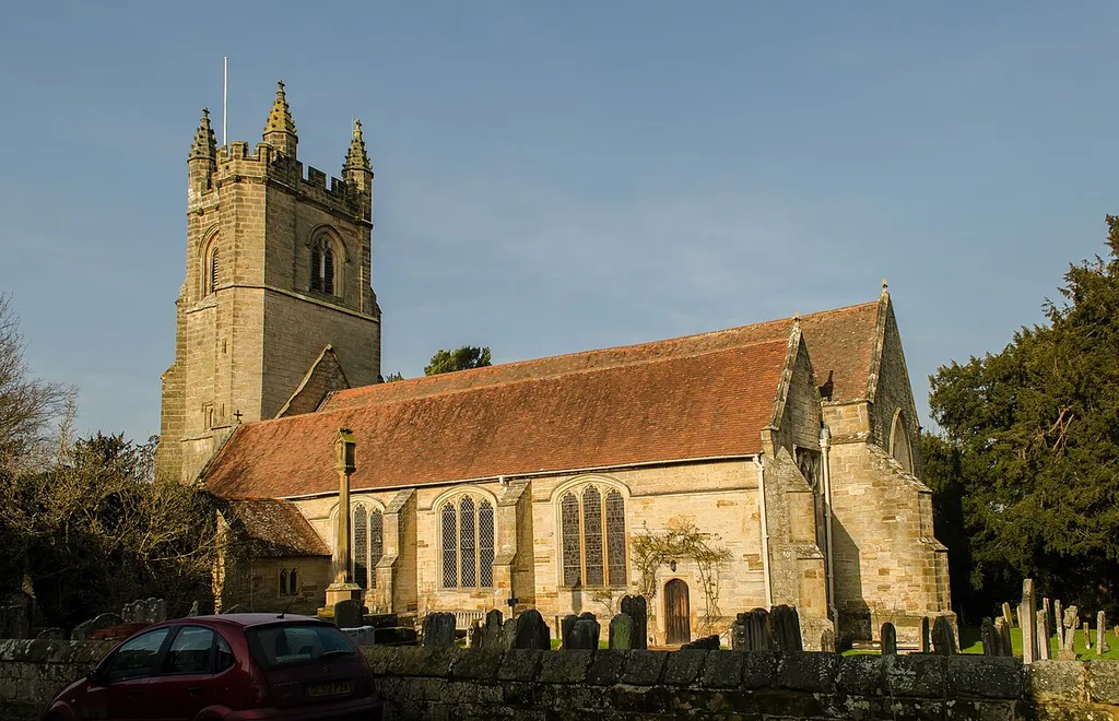 The church is built from local sandstone with tiled roofs, and dates from the early 14th century, although there were probably churches on the site before that. The west tower is perpendicular with four octagonal crocketted pinnacles and carved faces around the string course at the top. There are eight bells. The nave has a 4 bay arcade of early 14th century octagonal columns with pointed arches. The chancel has north and south chapels separated by a two bay arcade. In 1516 Sir Robert Reid enlarged the north Chapel to its present size and founded a Chantry. In 1624 the church was struck by lightning and caught fire, the extensive damage was not repaired until 1629 when the church was re-consecrated. A south porch was added. The nave roof was rebuilt with a flatter pitch, which can be seen on the side of the tower. The south wall of the south aisle was also rebuilt following the fire. Some of the earlier stonework may have been salvaged. There were two minor restorations in the Victorian era, the reredos was erected in 1866 and the seating revised. A chapel/meeting room was built at the base of the tower in 1978. The font dates from 1628 with an elaborate cover. The pulpit dates from the same period. The chancel has an altar tomb from 1650 to Frances Reeve of London and her two husbands. The church has a large collection of hatchments, and there is a elaborate brass chandelier from 1726, similar to the one at Sundridge. Most of the stained-glass is Victorian. The organ is by T. C. Lewis from circa 1868 and was upgraded by Walker in 1968. The churchyard has a vault of the Streetfeild family with a small building from the 18th century inside of which a flight of steps to the vault which contains some 15 coffins.