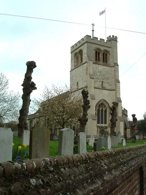 Church of England parish church of All Saints, Houghton Regis, Bedfordshire. Note the pollarded trees in the churchyard.