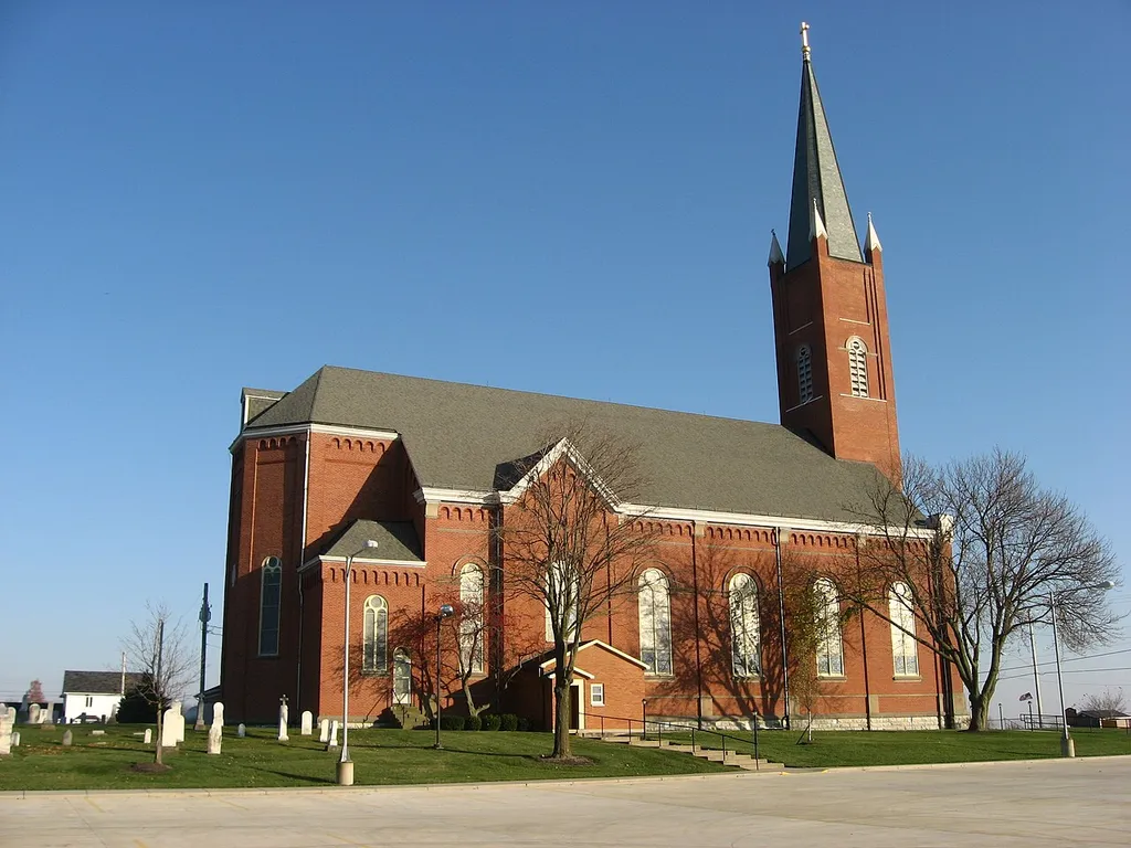 Rear and western side of St. John the Baptist Roman Catholic Church, located along State Route 119 in Maria Stein, an unincorporated community in Marion Township, Mercer County, Ohio, United States. Built in 1889, the church was listed on the National Register of Historic Places as a part of the Cross-Tipped Churches of Ohio Thematic Resources.