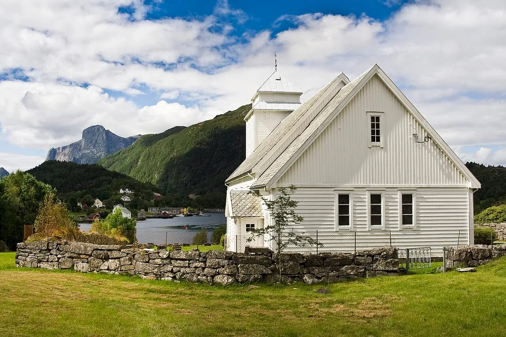 Rugsund Church in Nordfjord, Norway. The mountain visible furthest away is Hornelen.