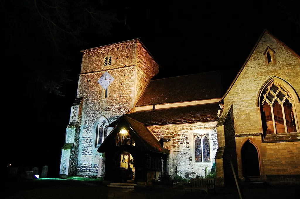 Nave and west tower of St Nicholas' parish church, Cranleigh, Surrey, seen from the south at night