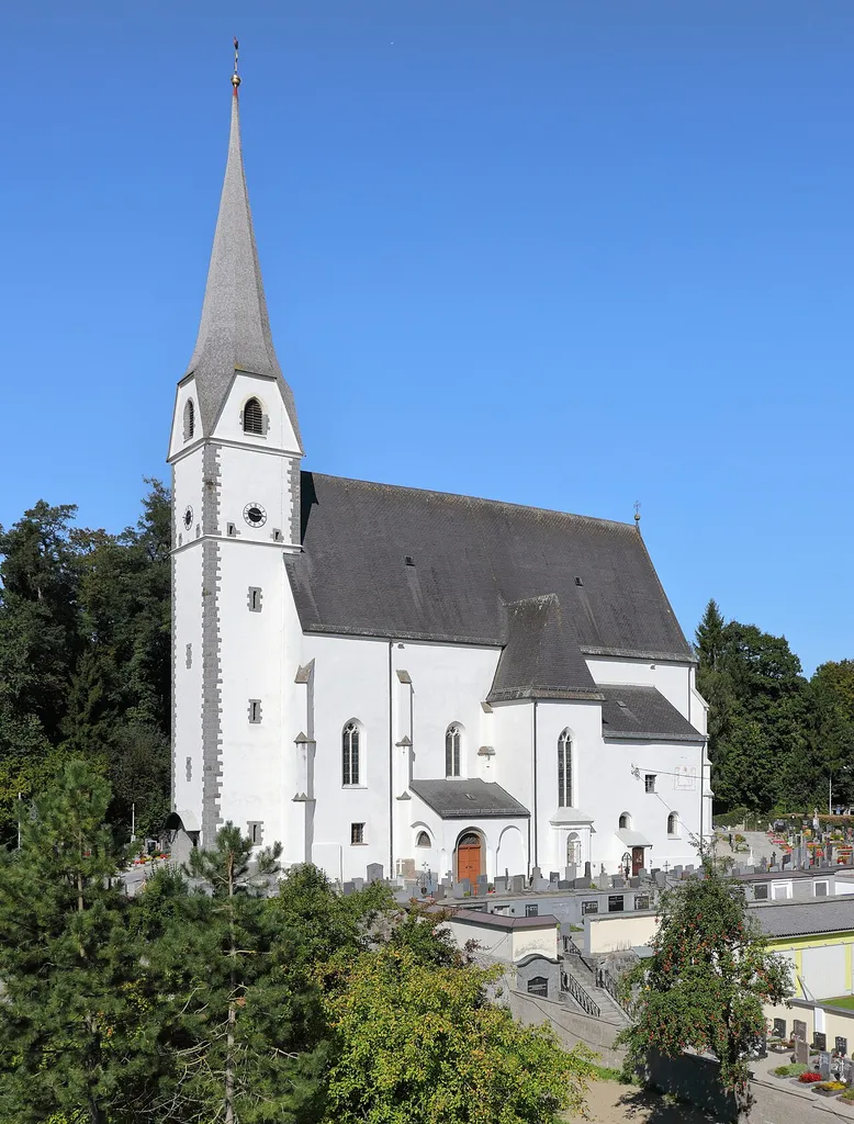 Südsüdwestansicht der röm.-kath. Pfarrkirche Mariä Verkündigung der oberösterreichischen Marktgemeinde Taufkirchen an der Pram.Die auf einem Hügel situierte gotische Kirche wurde nach der Mitte des 15. Jahrhunderts vermutlich durch den Baumeister Stephan Krumenauer erbaut. Der Turm stürzte 1922 ein und wurde 1923 in der alten Form wieder aufgebaut.