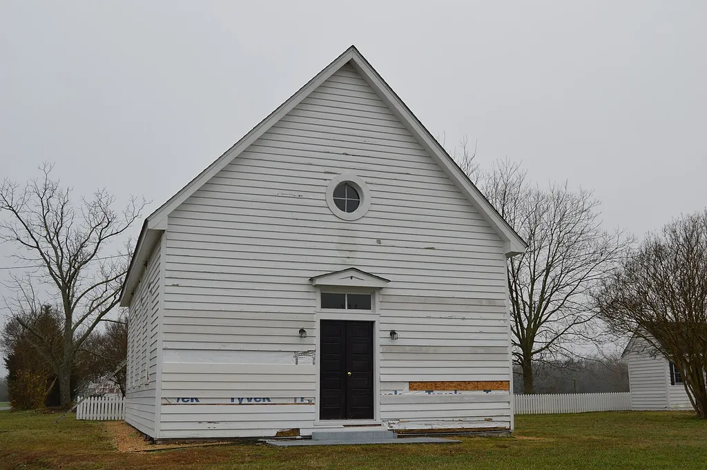 Front and southeastern side of the former Lanesville Christadelphian Church, located at the central intersection at Lanesville in King William County, Virginia, United States. It was built in 1876.