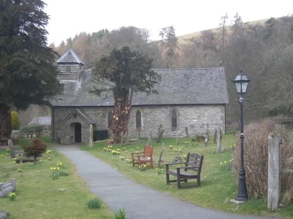 The church at Ratlinghope The Yew tree seems to have been a little 'over' pruned.