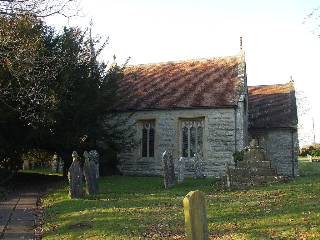 St Milburga's parish church, Wixford, Warwickshire. On the right next to the chancel is the base and broken stump of the 15th-century churchyard cross.