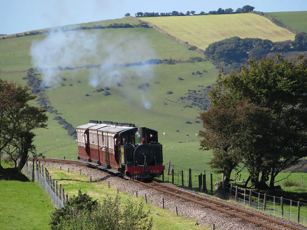 Lynton &amp; Barnstaple Railway. New-build replica Baldwin 2-4-2T No. 762 Lyn and its four-coach train head up the 1-in-50 gradient towards Woody Bay station during the railway's autumn steam gala.