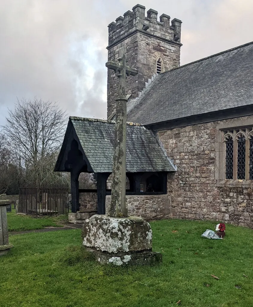 Grade II Listed medieval churchyard cross, Bryngwyn. In St Peter's churchyard near the entrance to St Peter's Church in the Church in Wales Diocese of Monmouth. The base is medieval. The cross shaft dates from c1900. Grade II Listed in 2000.