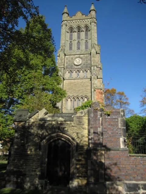 =West tower of the former Christ Church parish church, Crewe, Cheshire, seen from south-southeast. The tower was retained when much of the church was demolished in 1977 due to dry rot. In the foreground are parts of the walls of the former church.