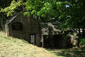 Stile, lychgate and former mortuary adjoining lychgate at south about 20m south-east of the Church of St Morwenna