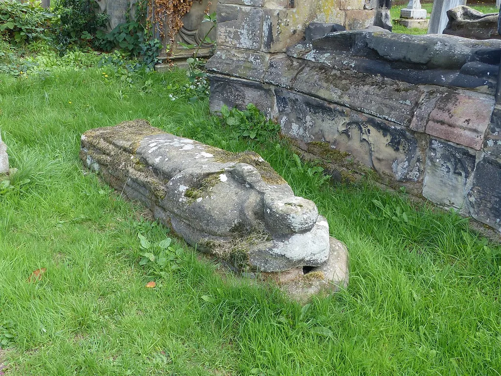 Grade II listed tombstone in the churchyard of St Mary's, Astbury, Cheshire. Listed as "Tombstone circa 1 yard to north of the Venables tomb in Churchyard of St. Mary at NGR 8463 6158". The Venables tomb (listed at Grade II*) is behind. .mw-parser-output .messagebox{margin:4px 0;width:auto;border-collapse:collapse;border:2px solid var(--border-color-progressive,#6485d1);background-color:var(--background-color-neutral-subtle,#fbfcff);color:var(--color-base,#202122);box-sizing:border-box;border-inline-start-width:8px}.mw-parser-output .messagebox.mbox-small{font-size:88%;line-height:1.25em}.mw-parser-output .mbox-warning,.mw-parser-output .mbox-speedy{border:2px solid var(--border-color-error,#b22222);background:var(--background-color-error-subtle,#ffdbdb);border-inline-start-width:8px}.mw-parser-output .mbox-serious,.mw-parser-output .mbox-delete,.mw-parser-output .mbox-stop{border:2px solid var(--border-color-error,#b22222);border-inline-start-width:8px}.mw-parser-output .mbox-issue,.mw-parser-output .mbox-content{border:2px solid #f28500;background:var(--background-color-warning-subtle,#ffe);border-inline-start-width:8px}.mw-parser-output .mbox-query,.mw-parser-output .mbox-style{border:2px solid #f4c430;background:var(--background-color-warning-subtle,#ffe);border-inline-start-width:8px}.mw-parser-output .mbox-shit{border:2px solid #960;border-inline-start-width:8px}.mw-parser-output .mbox-license{border:2px solid #88a;border-inline-start-width:initial}.mw-parser-output .mbox-legal{border:2px solid var(--border-color-notice,#666);background:var(--background-color-base,#fff);border-inline-start-width:8px}.mw-parser-output .mbox-honor{border:2px solid #ca3;background:var(--background-color-warning-subtle,#fcf4db);border-inline-start-width:8px}.mw-parser-output .mbox-growth{border:2px solid #8d4;background:var(--background-color-success-subtle,#d5fdf4);border-inline-start-width:8px}.mw-parser-output .mbox-move{border:2px solid #93c;border-inline-start-width:8px}.mw-p