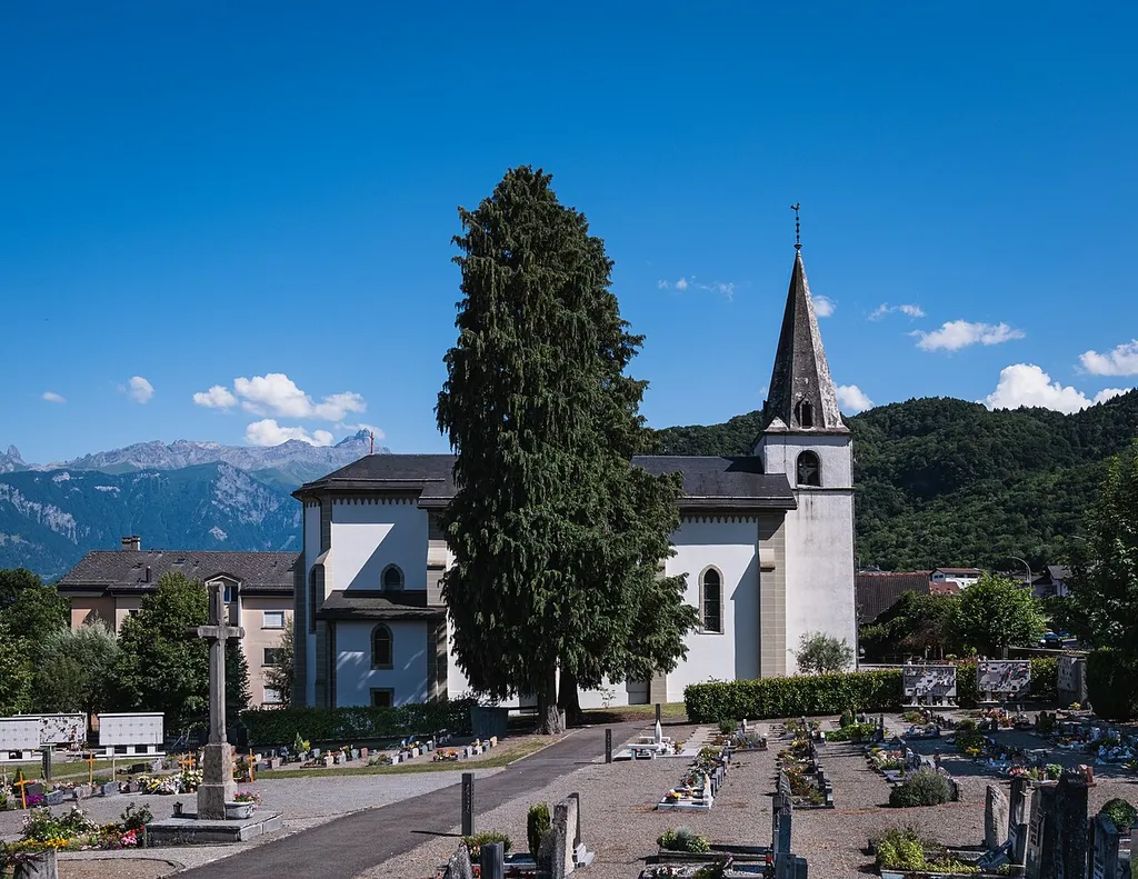 View from the Muraz cemetery of the parish church of Saint-André in Muraz, Switzerland.