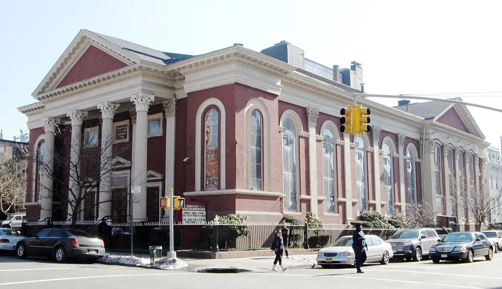 The church at 88 Hanson Place between South Oxford Street and South Portland Avenue in the Fort Greene neighborhood of Brooklyn, New York Cit was built in 1857-60 as the Hanson Place Baptist Church. It was designed by George Penchard in the Early Romanesque Revival style with a portico featuring Corinthian columns. The building was restored, inside and out, in the 1970s. It is now the Hanson Place Seventh-day Adventist Church. (Sources: Guide to NYC Landmarks (4th ed.) and AIA Guide to NYC (5th ed.)