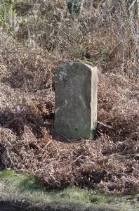 Milestone, on approach to old railway bridge