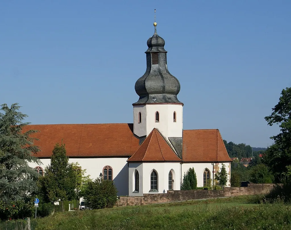 St. Katharina in Ernstkirchen in the bright morning sun. View from the road to the village Sommerkahl