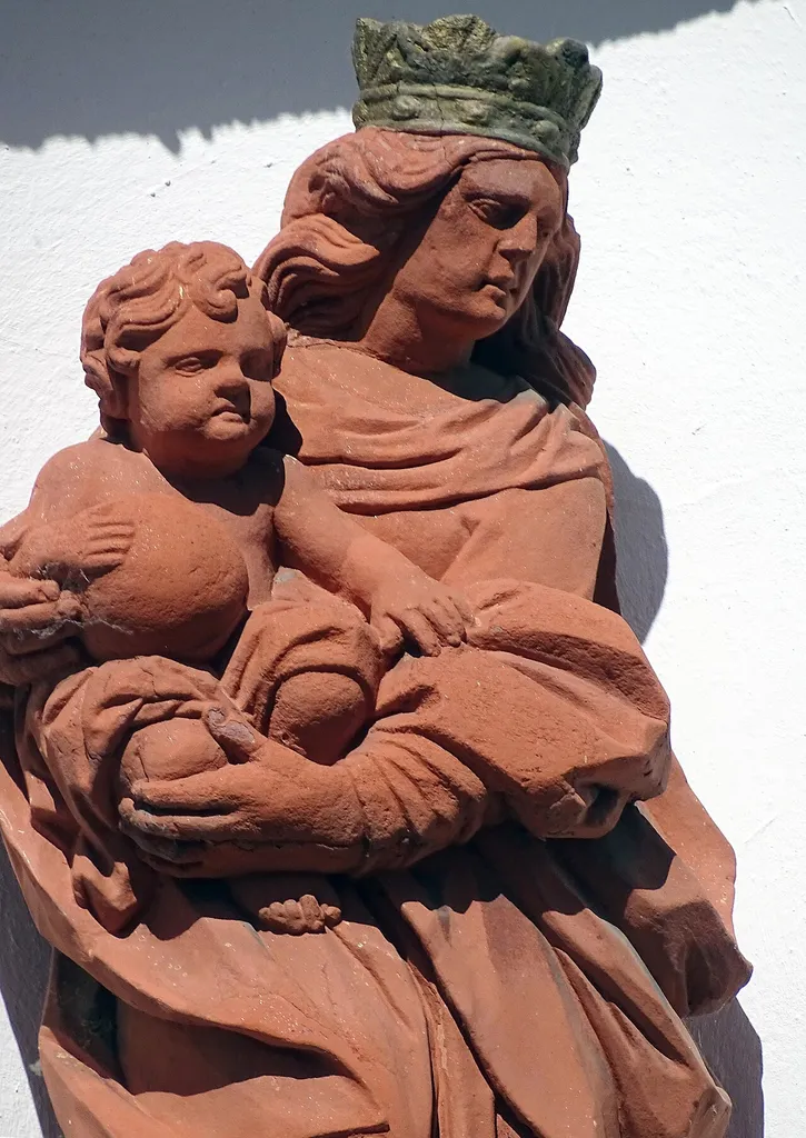 Partial view of the statue of Mary and child above the entrance of the former Laurentius church in Kleinostheim