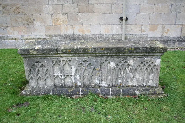 Early 14th-century chest or table tomb in St Katherine's parish churchyard, Loversall, South Yorkshire. The sides are adorned with 14th-century Decorated Gothic tracery.