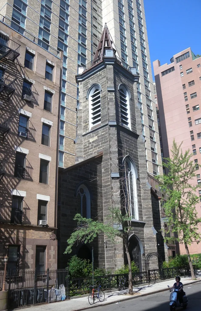 Looking west across 12th Street at former St Ann's Church, now entry hall for dormitory, on a sunny morning.