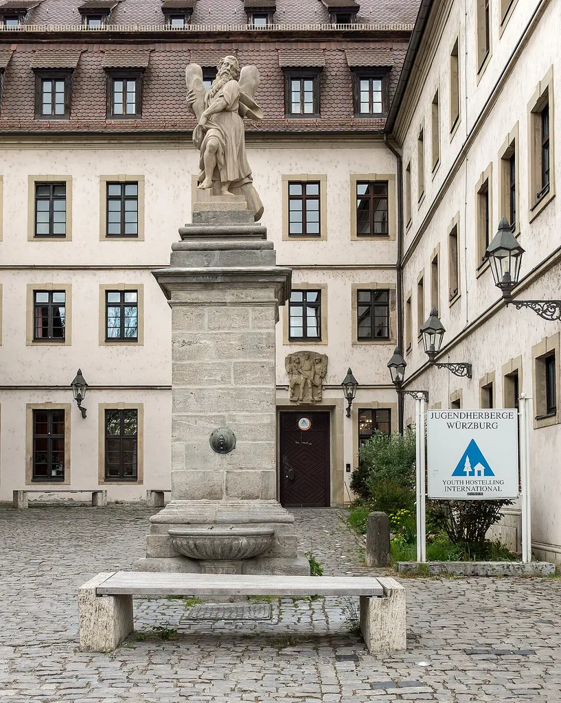 Würzburg, Fred-Joseph-Platz 2, Laufbrunnen (auch: Andreas-Brunnen), Pfeilerpostament mit Brunnenschale und Bekrönung durch Figur des heiligen Andreas, Sandstein und Kalkstein, barock, Andreas Müller, Anfang 18. Jahrhundert III Akt.Nr.D-6-63-000-88