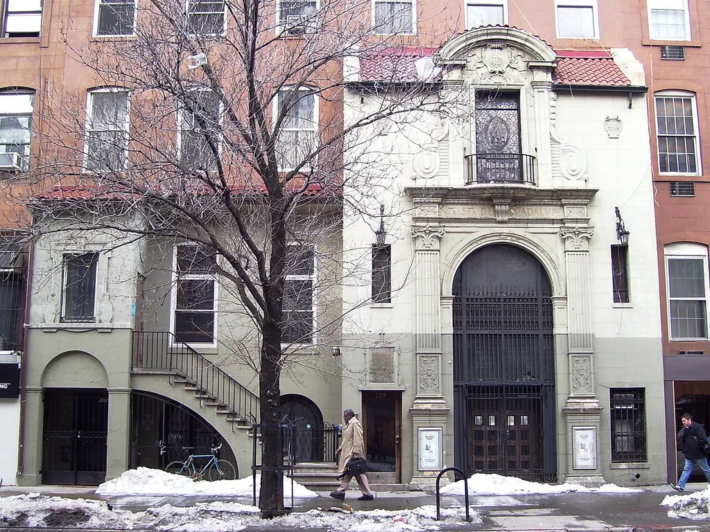 Iglesia Nuestra Senora de la Guadalupe (Church of Our Lady of Gaudalupe) was founded in 1902, the oldest Spanish-speaking Roman Catholic parish in New York City, and the brownstone rowhouse at 229 West 14th Street between Seventh and Eighth Avenues in Manhattan, had its Spanish Baroque facade added in 1921. The facade was designed by Gustave Steinbeck. In 2003, the parish moved down 14th Street to the Church of St. Bernard, which became Our Lady of Gaudalupe at St. Bernard's. (Source: From Abyssinian to Zion (2004))