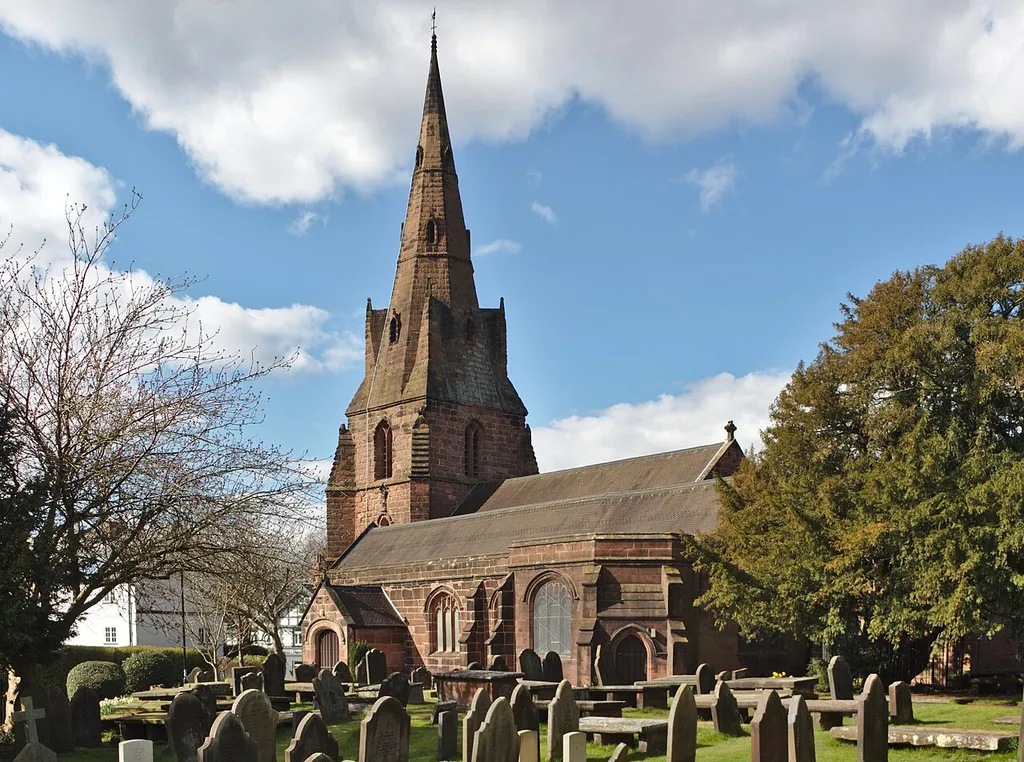 Grade II listed church of St Mary, Eastham Village, Wirral. View across the churchyard from the southwest. Eastham Old Yew is at the right.