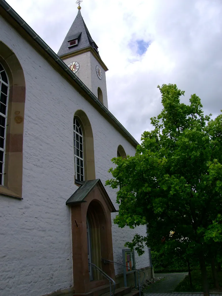 Doorway and steeple of the protestant church of Mannweiler, Germany.