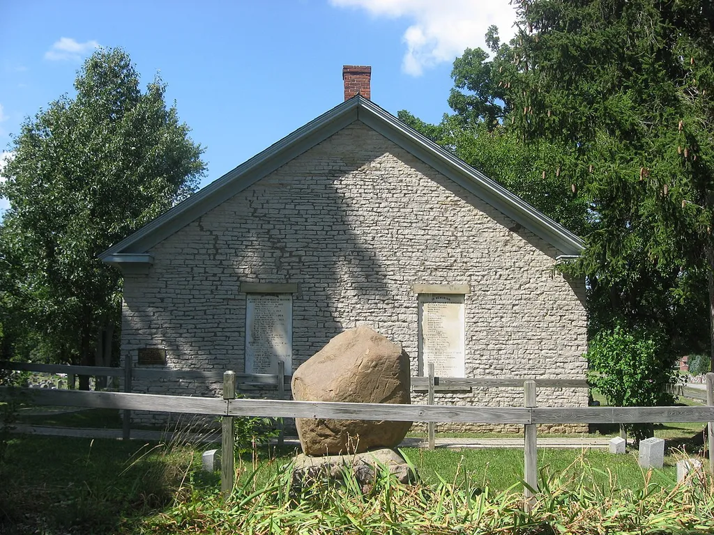 Front and side of the Wyandot Mission Church, located in the city cemetery off Church Street on the northern side of Upper Sandusky, Ohio, United States. Built in 1824 as a Methodist mission to local Wyandots, the stone church is listed on the National Register of Historic Places.