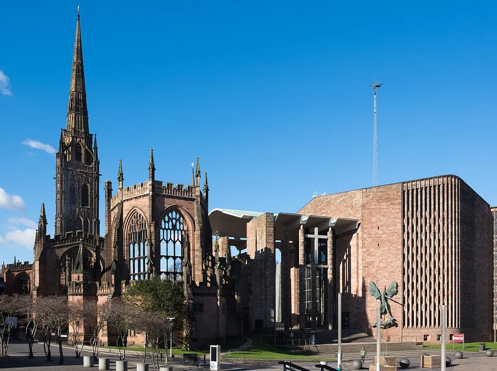 Coventry Cathedral comprising the war-ruined 14th-century St Michael's Cathedral on the left (its 90-metre spire survived intact) and the 1960s Cathedral Church of St Michael on the right. Both are grade I listed buildings in England.