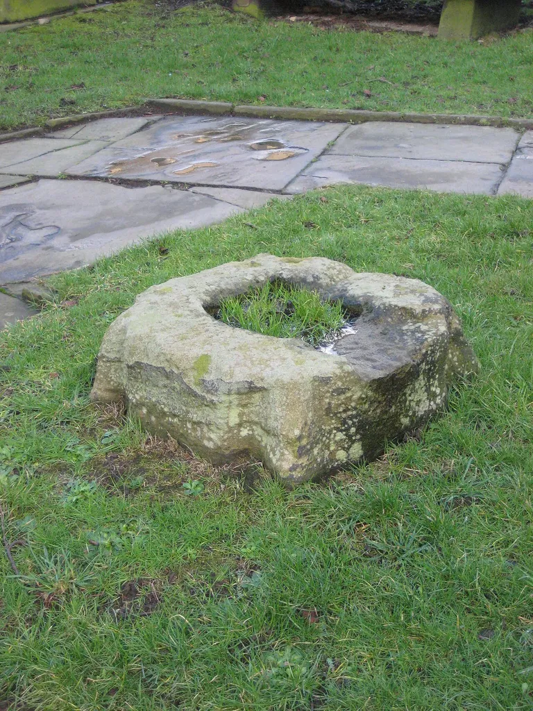 Photograph of the cross base in the churchyard of St John's Church, Penistone, South Yorkshire, England