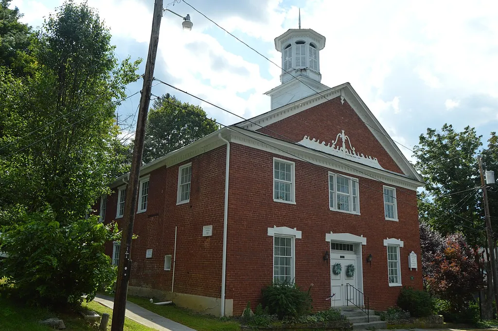 Front and eastern side of the John Wesley Methodist Church, located on the southern side of Foster Street east of the Lafayette Street intersection in Lewisburg, West Virginia, United States. Built in 1820, it is listed on the National Register of Historic Places.