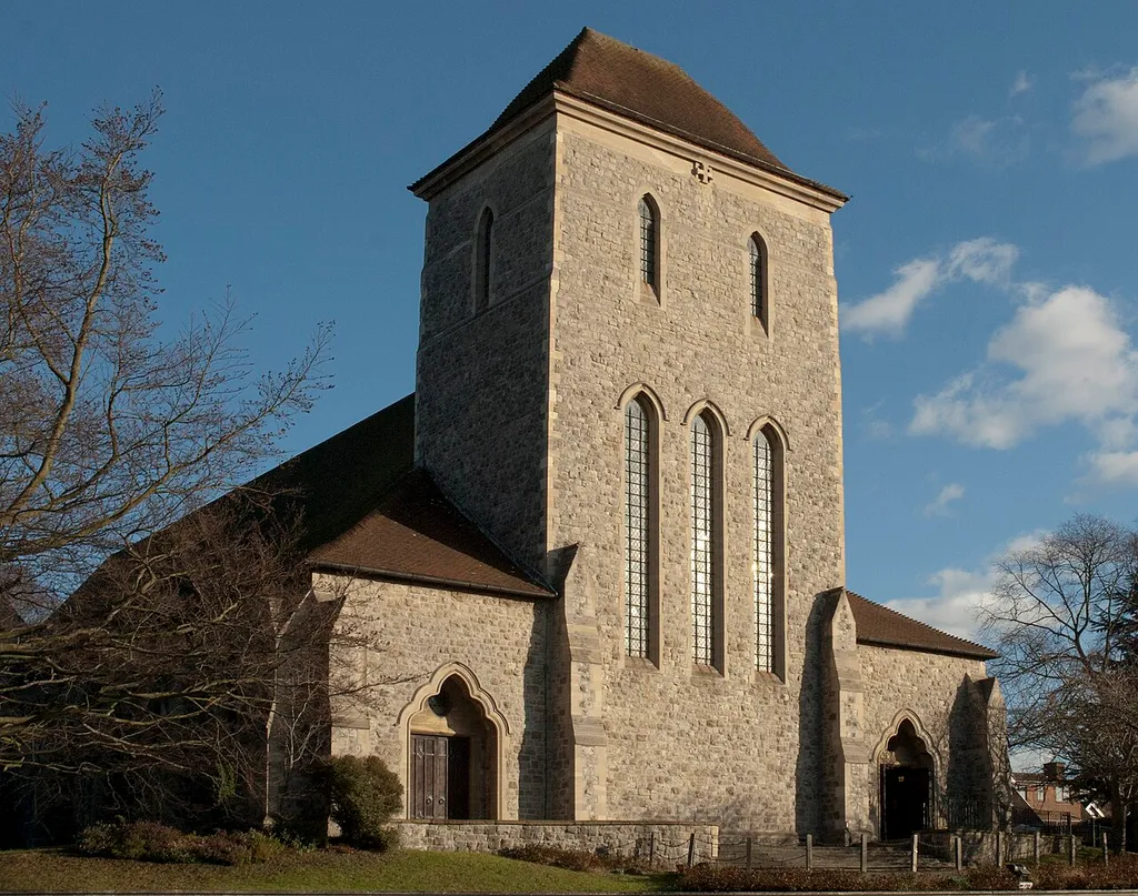 All Saints' Hockerill, Bishop's Stortford. Architecture by Stephen Dykes Bower. West front with central tower and flanking aisle entrances.