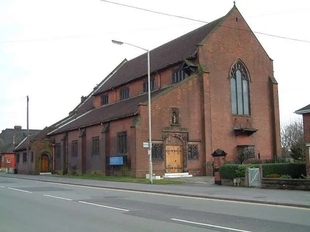 All Saints Church, Joiners Square Church. 1910-13, by Gerald Horsley. Gothic Revival style. Red brick, with ashlar dressings and plain tile roof with coped gables. Chancel with organ chamber, north chapel and vestry, nave with arcades and clerestory, north aisle. Windows are mainly pointed arched lancets with stone mullions