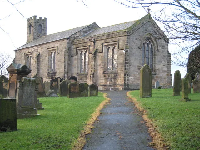 Gravestones in the Parish Church of Seamer This photograph shows the approach to Seamer church and, on either side, some of the gravestones that are located within the grounds of the church.