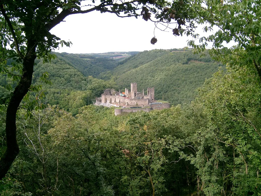 The Castle of Brandenbourg, Luxembourg, surrounded by mixed forests. View from south, viewpoint on the hill named Köpp. The valley of the Millebaach in the background.